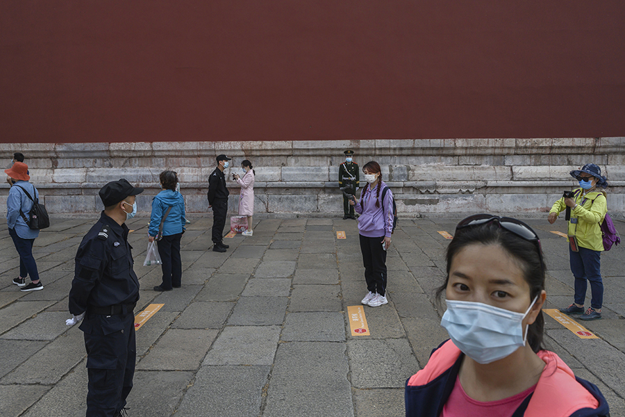 Китайские туристы стоят в очереди, чтобы попасть в &laquo;Запретный город&raquo;, который был закрыт для посещения более трех месяцев
