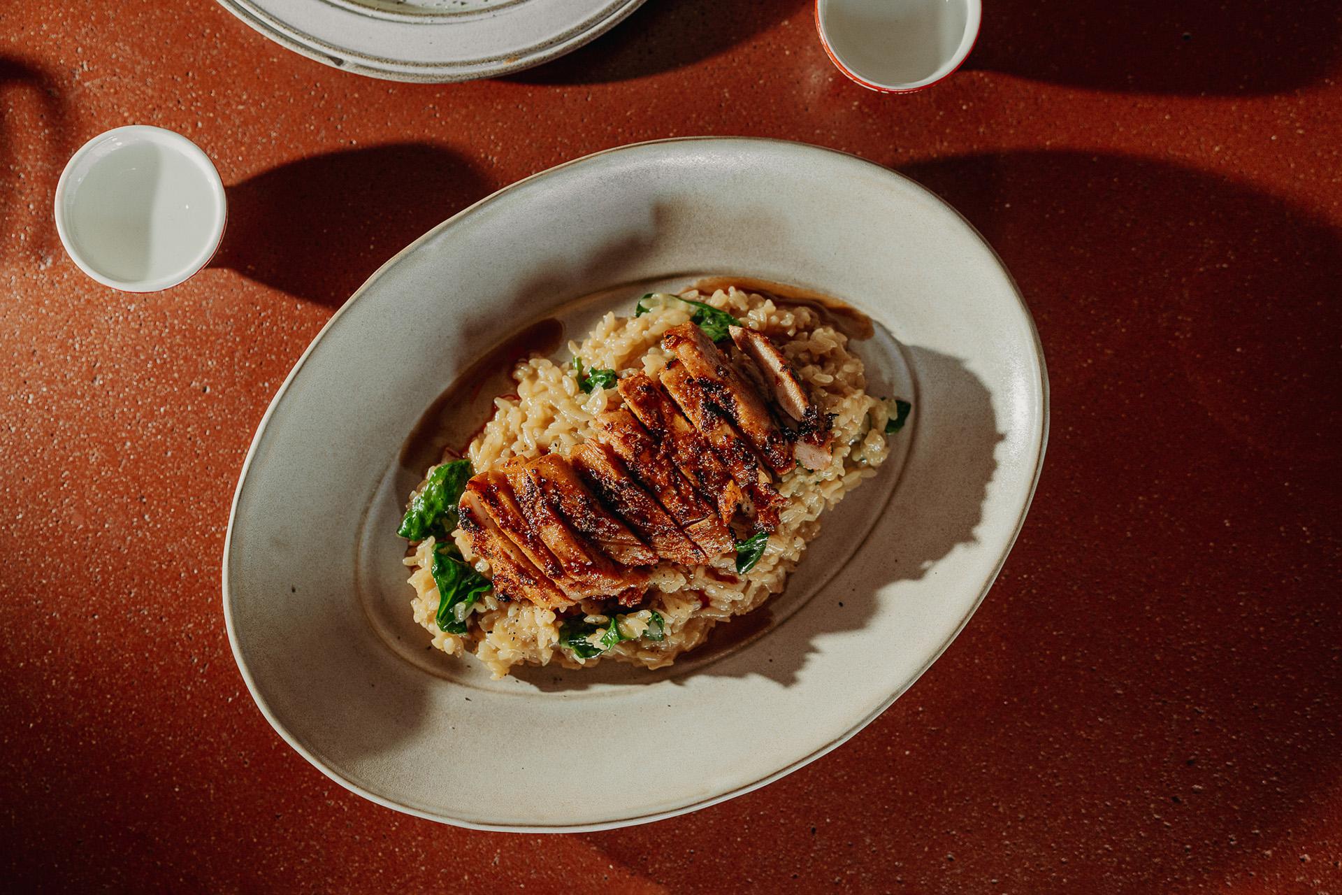 Жареный рис с курицей в йогуртовом маринаде, кокосовым соусом ахи-амарилло и чесночным маслом в ресторане Maya