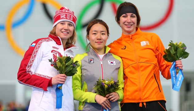 (Слева направо) Серебряная медалистка Ольга Фаткулина из России, золотая медалистка Sang Hwa Lee из Южной Кореи и бронзовая медалистка Margot Boer из Нидерландов на подиуме во время церемонии награждения по скоростному бегу на коньках на 500м