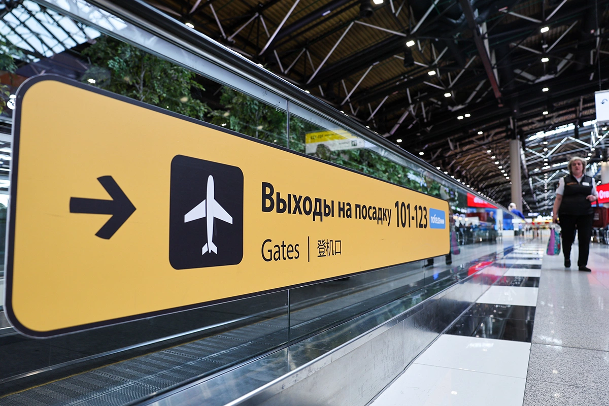 <p>Табличка, указывающая направление к выходам на посадку, в международном аэропорту Шереметьево</p>
