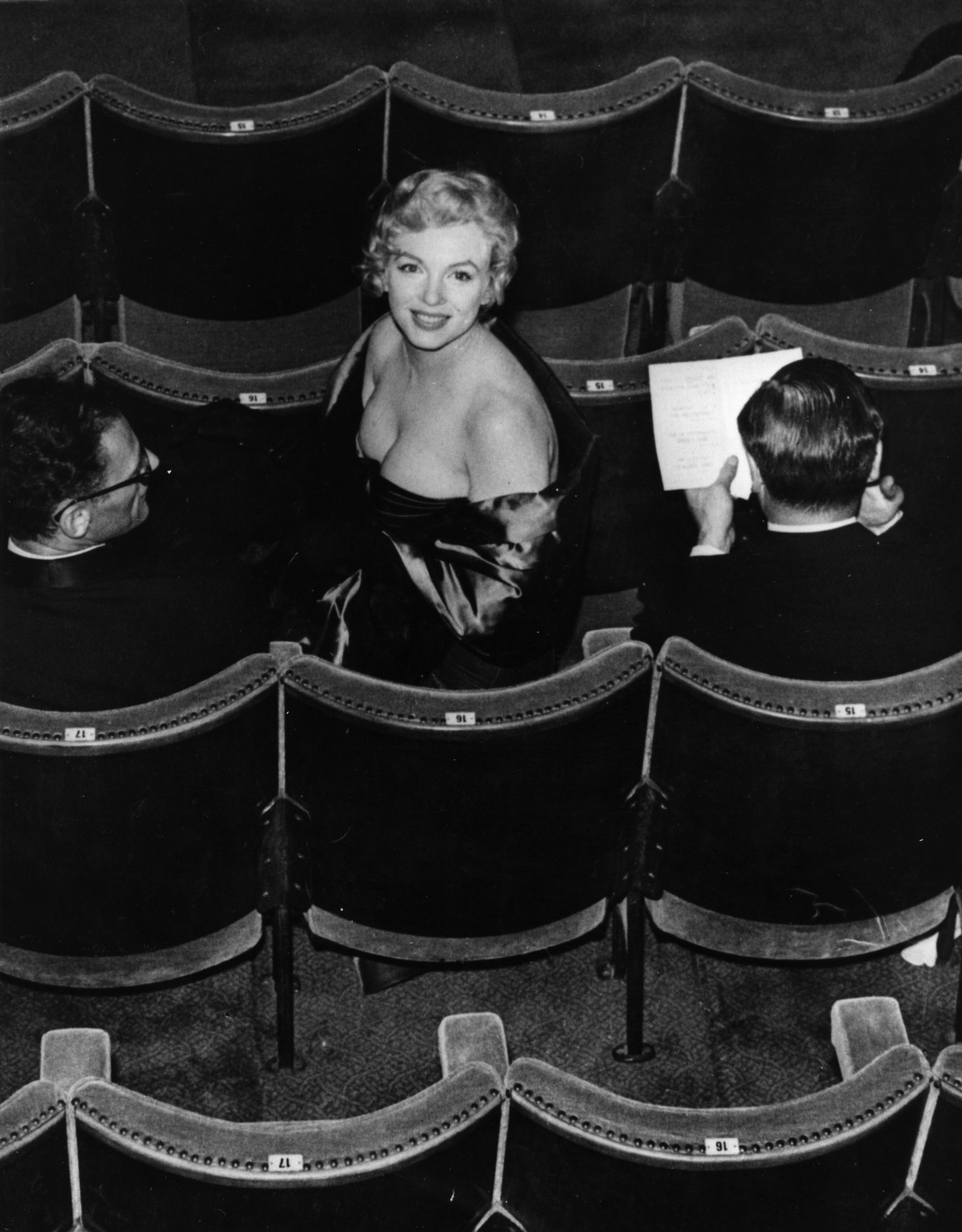 <p>На этом фото Мэрилин Монро в Театре комедии в Лондоне на премьере пьесы &laquo;Вид с моста&raquo;, которую написал Артур Миллер (он сидит слева), 12 октября 1956 года.</p>

<p>Последней работой Монро в кино стал фильм &laquo;Неприкаянные&raquo;&nbsp;1961 года. Она снялась в нем вместе с Монтгомери Клифтом и Кларком Гейблом (его на съемочной площадке хватил удар, и вскоре он умер, а через год скончалась и Мэрилин&nbsp;&mdash; такой мрачный факт). Сценарий к фильму написал Артур Миллер специально для Монро&nbsp;&mdash; она сыграла драматическую роль Розлин, пытающейся развестись с мужем. Картина, впрочем, провалилась в прокате, но получила признание критиков за актерскую игру и сценарий. Вскоре вообще стала считаться шедевром, одним из лучших фильмов 1960-х</p>