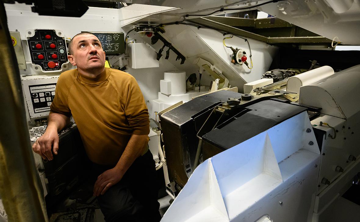 Новобранец с Украины выполняет упражнения на тренажере, который имитирует процесс заряжания и стрельбы из орудий танка Challenger 2