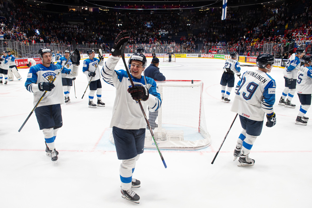 Хоккеисты сборной Финляндии празднуют победу с болельщиками
