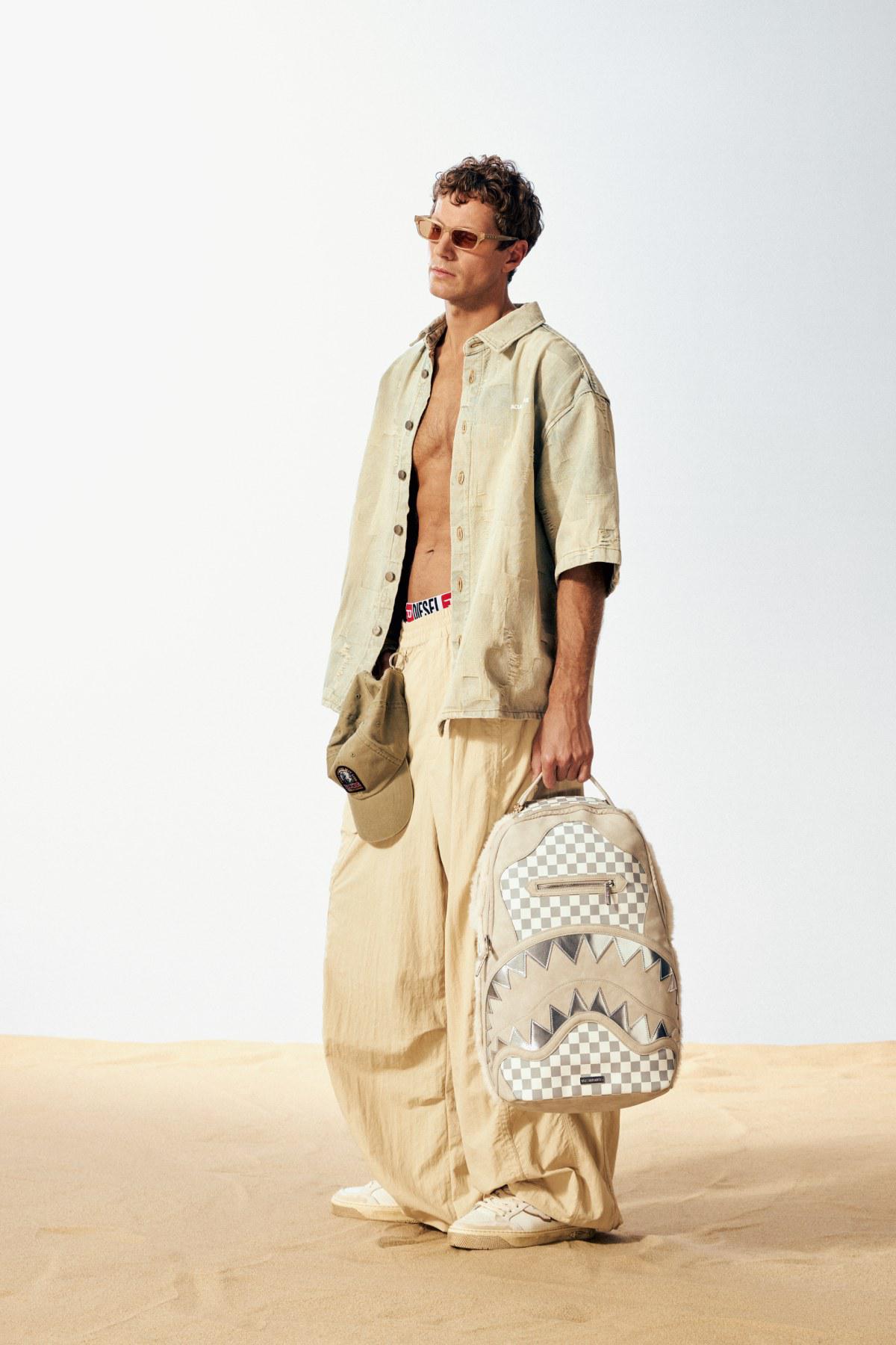Рубашка Acupuncture, брюки Etudes Studio, кепка Parajumpers, очки Marni, рюкзак Sprayground, кеды Enterprise Japan