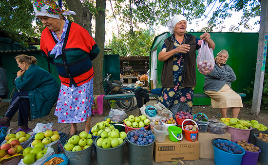 Женщины торгуют овощами и фруктами на рынке города Полтава