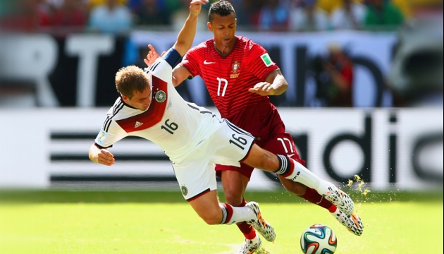 Немец Филипп Лам в борьбе за мяч с португальцем Нани во время матча в Группе G Германия - Португалия. 