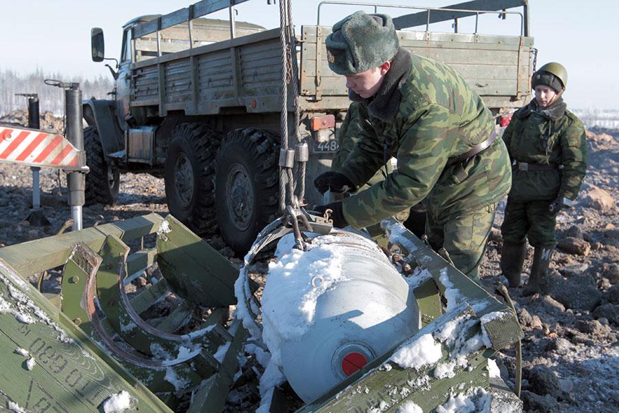 Солдаты-срочники выгружают фугасную авиационную штурмовую бомбу ФАБ-500Ш для подрыва на авиационном полигоне &laquo;Туганы&raquo;, 2011 год