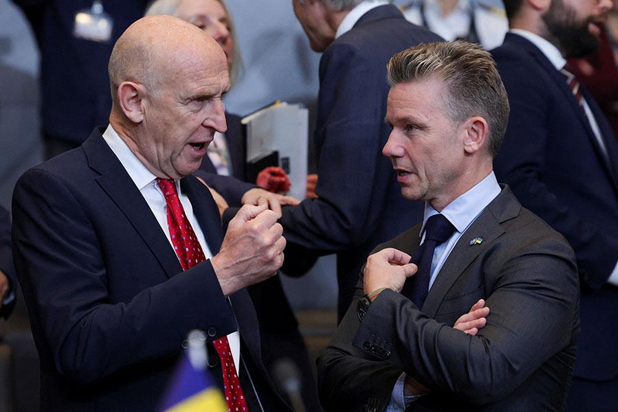 Государственный секретарь Великобритании по вопросам обороны Джон Хили беседует с министром обороны Швеции Пэлом Джонсоном на заседании Североатлантического совета в Брюсселе, Бельгия, 15 октября 2025 года