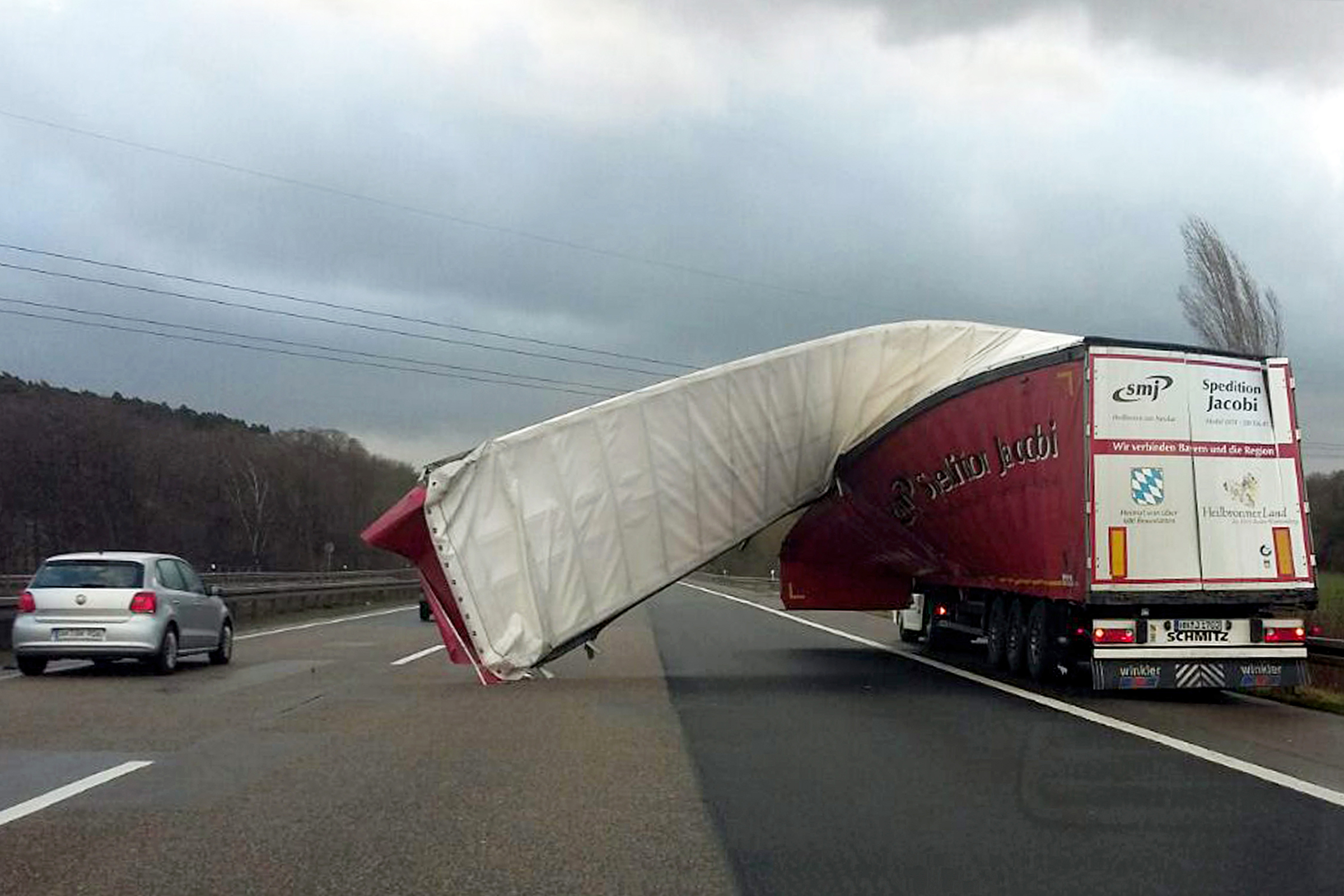 A truck&#39;s tarpaulin is blown off on to the motorway due to strong winds near Wuppertal, Germany, 18 January 2018