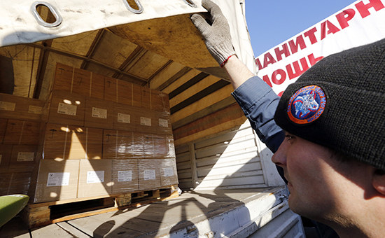 Сотрудник МЧС демонстрирует груз одной из машин колонны МЧС России с гуманитарной помощью для жителей Донецкой и Луганской областей