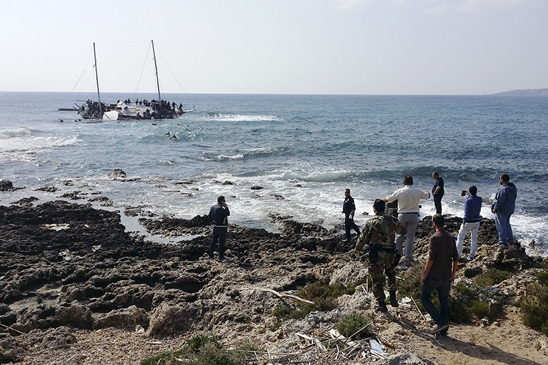 Греческие офицеры береговой охраны наблюдают за кораблем с нелегалами у побережья острова Родос&nbsp;
