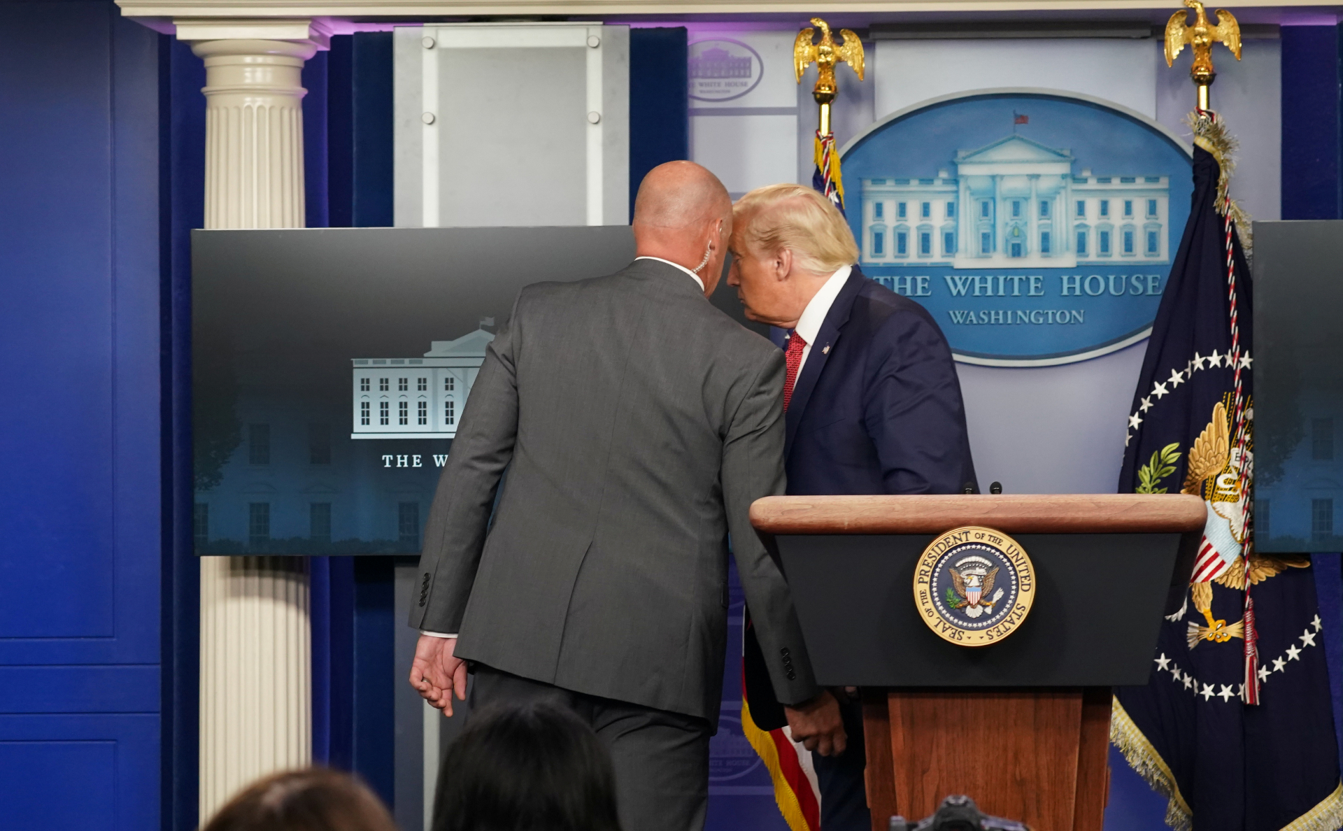 Охрана уводит Дональда Трампа (справа) с пресс-конференции