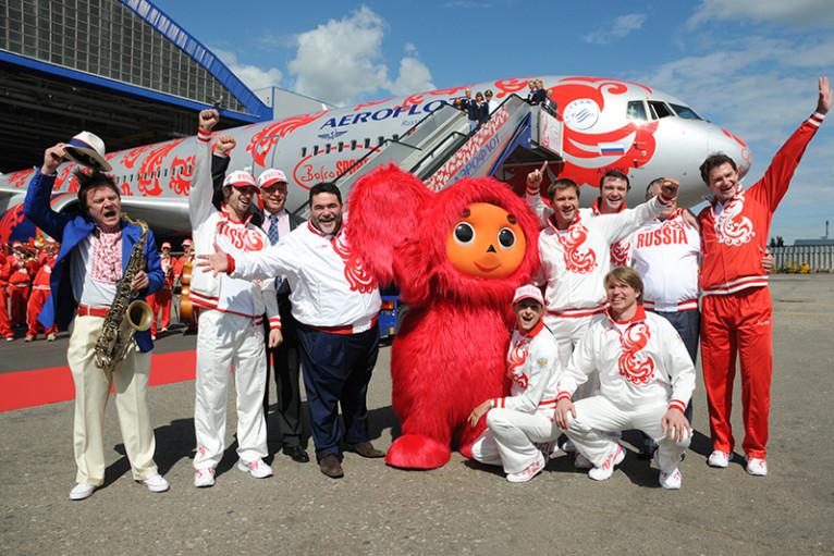 Саксофонист Игорь Бутман, фигурист Илья Авербух, Михаил Куснирович, гимнаст Алексей Немов, фигуристы Антон Сихарулидзе, Алексей Тихонов (слева направо на втором плане), спортсменка по синхронному плаванию Ольга Брусникина и шпажист Павел Колобков (на первом плане) во время проводов олимпийской сборной России в аэропорту Шереметьево-2