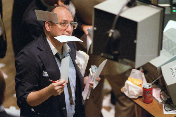 (Original Caption) New York: As busy as a beaver once again 9/12 a floorman at the New York Stock Exchange takes orders during record volume day that saw the Dow Jones industrial average rise and fall like a roller coaster.